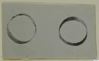 Two gold rings lying side by side on a pale card, from the Kastros tombs at Lapithos