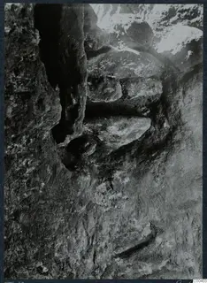 Tomb 10 at Milia during excavation, showing the rock-cut tomb chamber with stone slabs lying against its walls
