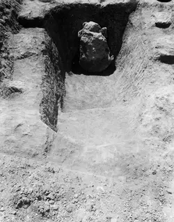 Dromos of Tomb 317 at Lapithos, a sloping cut in the ground leading up to the tomb opening, with a large stone at its end