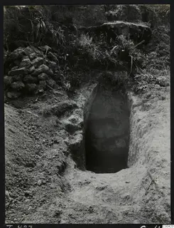 Tomb 423 at Lapithos during excavation, showing the dark chamber opening at the end of a cut in the ground