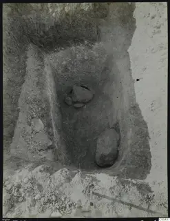 Tomb 312 at Lapithos, Vrysi tou Barba, during excavation, with large stones lying in the tomb chamber.