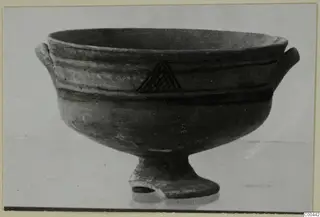 Footed bowl with two small horizontal handles, dark painted bands and a hatched triangle, from the Kastros tombs at Lapithos