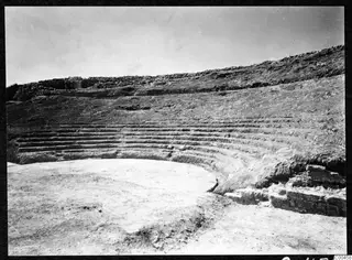 The theatre at Soli, with curved tiers of stone seating around an excavated circular orchestra.