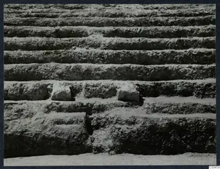 Stepped tiers of excavated earth at the theatre at Soli, with two stone blocks set into the steps