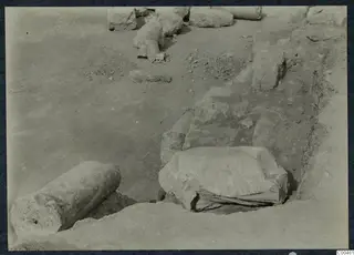 Excavation at Soli theatre with fallen stone column drums and blocks lying in the dug ground.