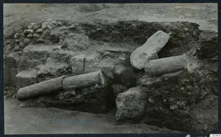 Excavated trench at Soli with two column drums lying on stone walls and a broken stone block beside them