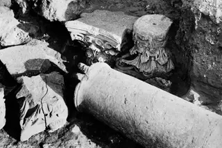 Column drum and carved capitals lying in an excavated trench at Monasteraki, Soli.