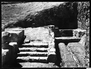 Excavated stone steps at the theatre at Soli, with walls and a trench beside them.