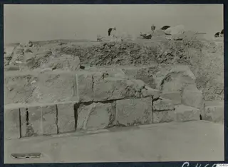 Excavated stepped masonry of large squared blocks at the Theatre at Soli, with a bucket and stones behind