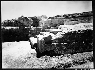 Excavated stone steps of the theatre at Soli, with dressed blocks and a cut trench in the foreground.