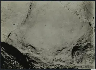 Excavated cutting at Soli with rough earth and rock walls around a smooth, pale floor.