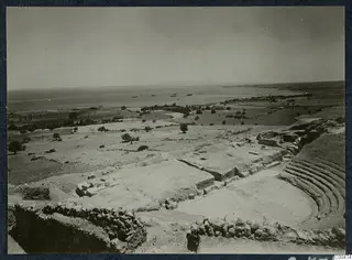 Excavated theatre at Soli, with curved rows of seating, low walls and the sea beyond
