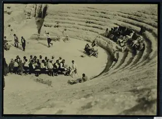 The theatre at Soli with seated people in the orchestra and on the tiers during a festival