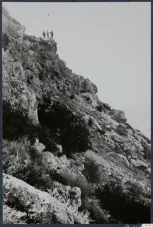 Steep rocky hillside at Vouni with three people standing on the ridge above