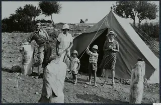 The Gjerstad family and their nanny outside a tent at Vouni, with limestone sculptures among them