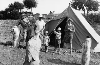 The Gjerstad family and their nanny outside a tent at Vouni, with limestone sculptures among them