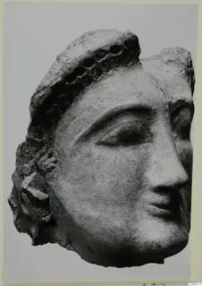 Terracotta head from Vouni, shown in three-quarter view with a dotted band across the hair