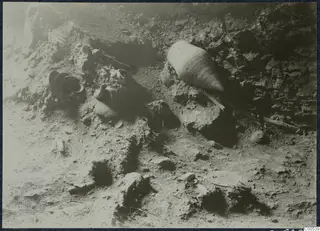 Pottery vessels and stones lying in situ in an excavated area at Vouni Palace