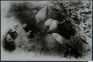 Several pottery vessels lying in situ in an excavated hollow at Vouni
