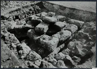 Large stone blocks lying in an excavation trench at Vouni