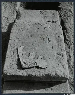 Large stone blocks partly uncovered during excavation at Vouni, one with a broken fragment of stone resting on its face.