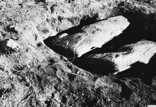 Two large stone pieces lying in an excavated trench at Vouni Palace
