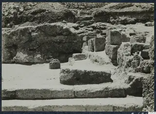 Excavated stone wall, blocks and steps at the palace at Vouni, with no people visible.