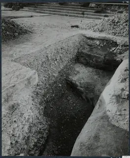 Excavation trench at Vouni with exposed stone blocks and a stone staircase behind it