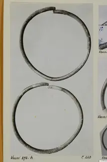 Two open metal bracelets from Vouni, photographed on a mounted card with other photographs at the right edge