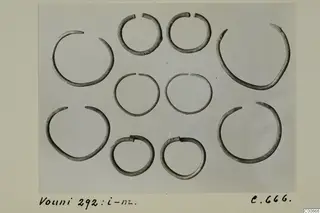 Silver hoop bracelets from Vouni 292 laid out in rows on a pale grey background