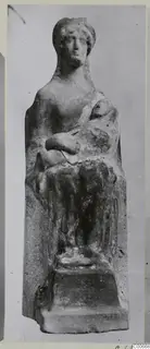 Terracotta figurine of a seated adult holding a child in the lap