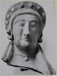 Terracotta bust from Vouni with a tall headdress set with round studs, its lower edge broken away.