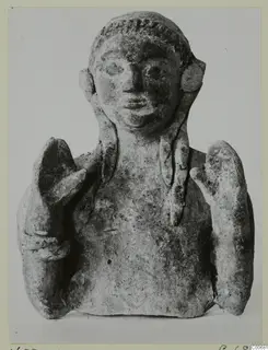 Small bust of a figure with braided hair and raised hands, from Vouni