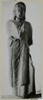 Limestone statue of a standing figure from Vouni, with hair framing the head and drapery falling in vertical folds