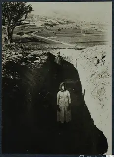 Test trench 2 at Pezoullia, Soli, with two women and a man standing in the trench.