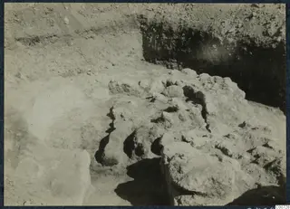 Excavation at Vouni Palace showing exposed stones and rubble in a trench