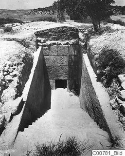 Dromos of Tomb 1 at Trachonas: a stepped passage leading down to a tomb entrance set in a stone-block facade.