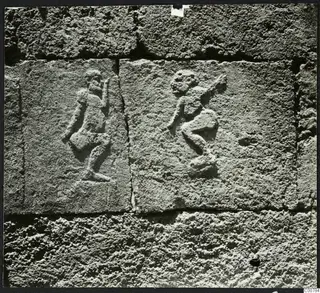 Two carved relief figures on dressed stone blocks at Trachonas, Tomb 1