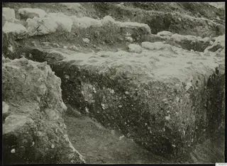 Excavation trench at Plakes, Lapithos, with rows of stones exposed in the soil face