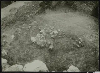 Excavation at Plakes, Lapithos, with scattered stones in the dug ground