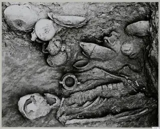 Skeleton and pottery vessels in Tomb 602 at Lapithos during excavation