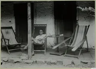 Erik Sjöqvist seated in a deck chair on a stone-paved veranda at Machairas