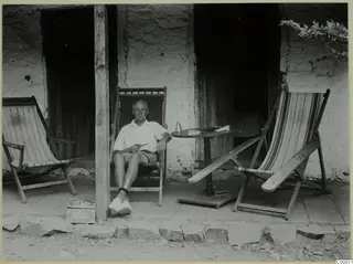 John Lindros seated in a deck chair on a veranda at Machairas.