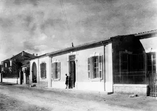 The Swedish Institute building in Nicosia, a long whitewashed house with shuttered windows on a dirt street.