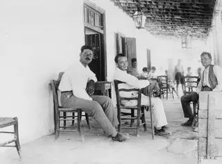 Erik Sjöqvist, Lazaros and Giorkos seated on a veranda at Idalion.