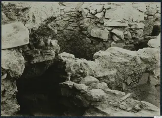 Excavated stone walls and fallen stone blocks at the Idalion acropolis during excavation