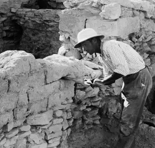 Man sawing into the brick wall L8 during excavation at Idalion