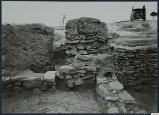 Excavated stone wall complex at Idalion, seen from the north, with a tripod and a wooden frame on the skyline.