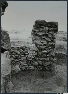 Standing stone wall remains on the Idalion acropolis, with a wall running left beside a tall rubble-built pier.