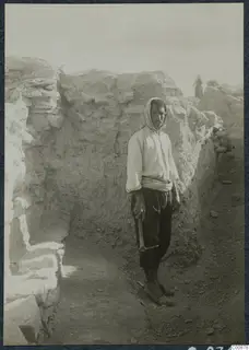 Osman with a pick, standing in a trench at Idalion